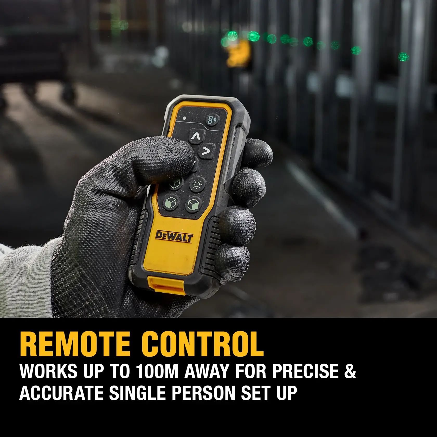 A DEWALT 18V XR green laser level is mounted on a tripod in an industrial construction setting. The device projects bright green laser lines, and there is a worker in safety gear visible in the background standing on scaffolding.