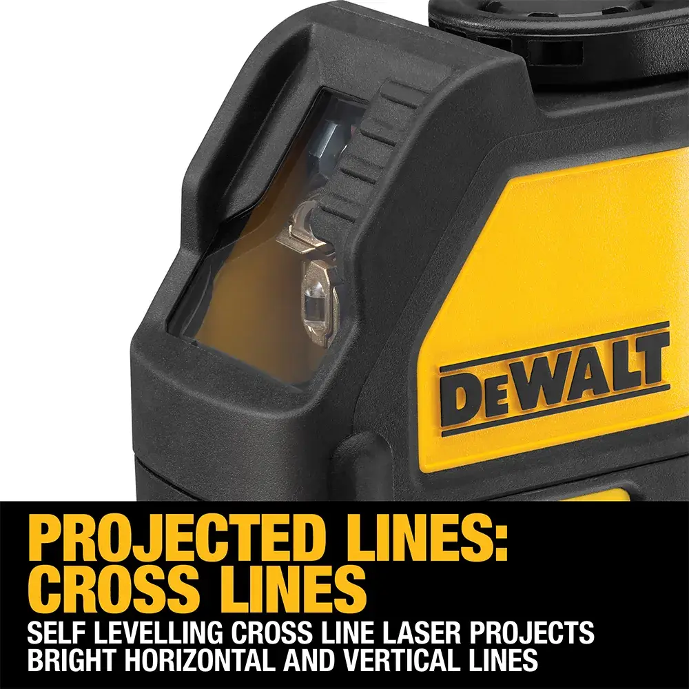A DeWalt laser level tool projecting a green laser line across a concrete floor in an unfinished building with exposed metal framing.