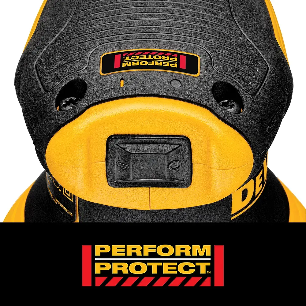A person is changing the sandpaper pad on a DEWALT electric orbital sander, which is being used to work on a wooden surface.