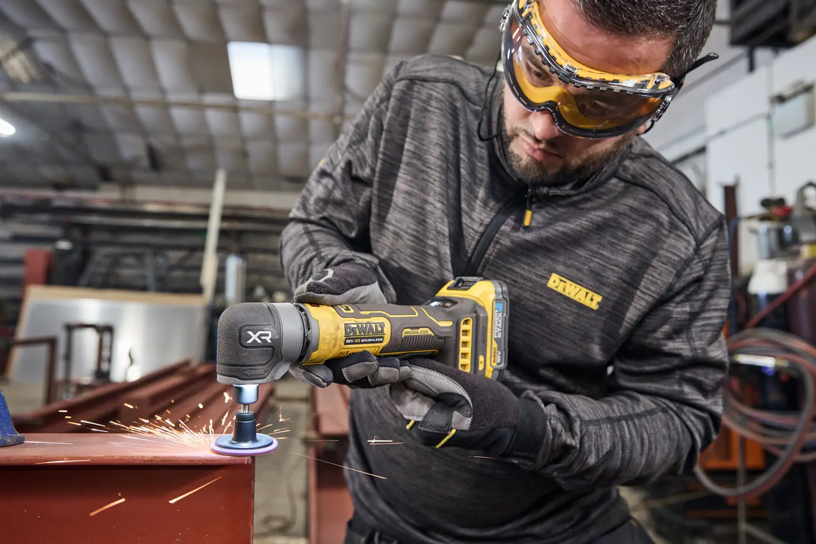 Worker uses DEWALT tool DCG421N-XJ, DCG421N to grind metal. Sparks flying. Photography product category.