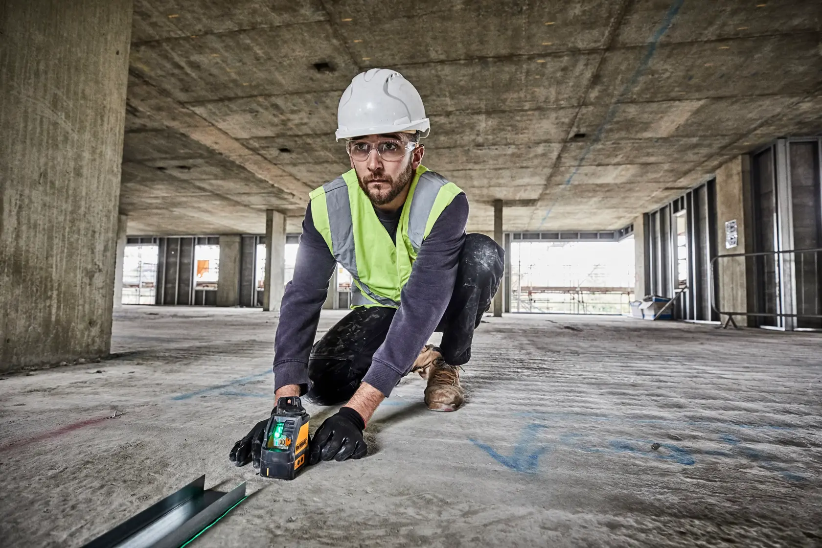 A DEWALT DW088CG green cross line laser level, with a yellow and black casing, side view showing the DEWALT logo and control buttons.